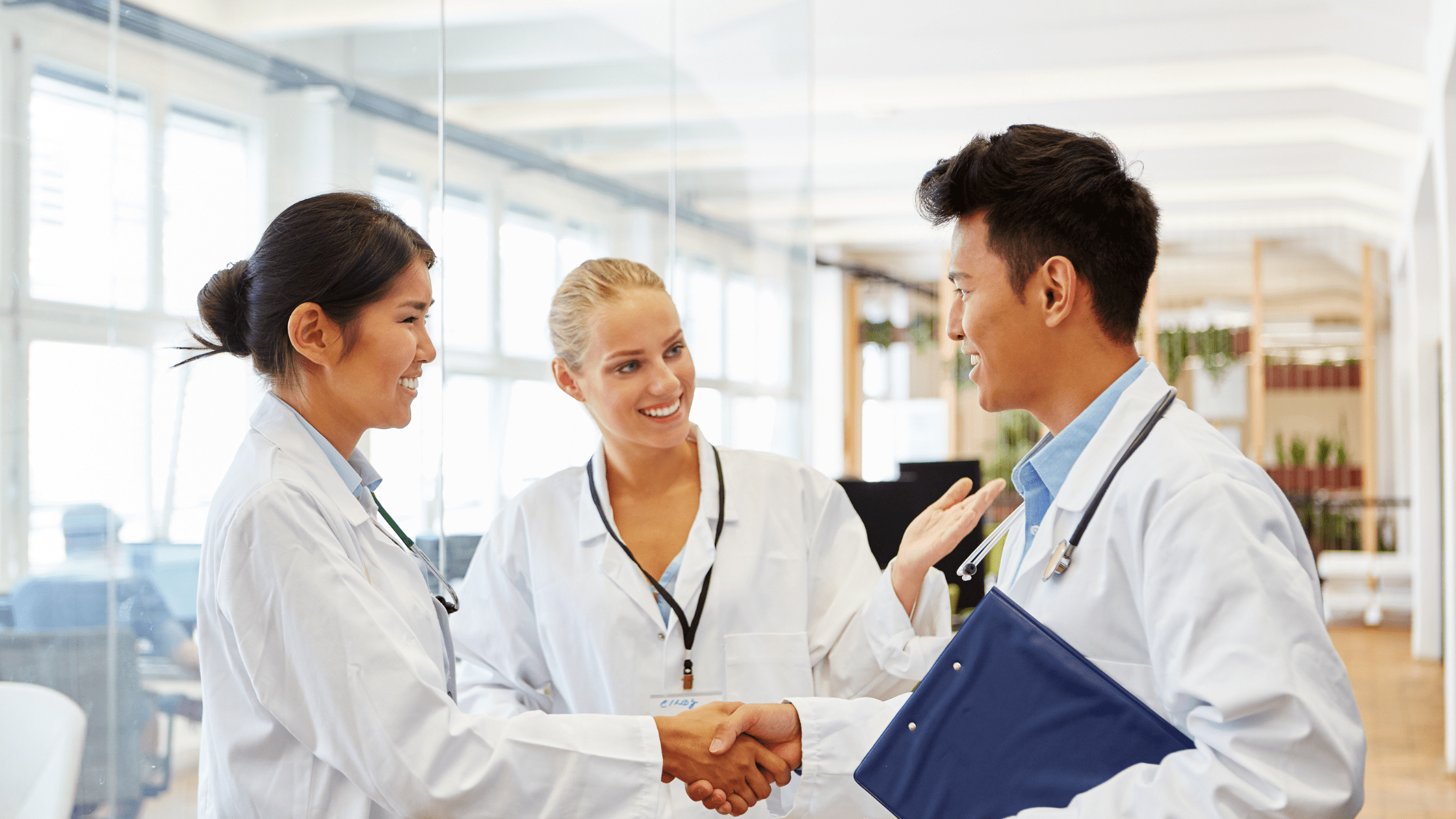 A team of DO residents in a hospital wearing lab coats.
